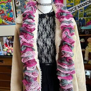 Pink and multicolored crochet scarf with unique ruffles.